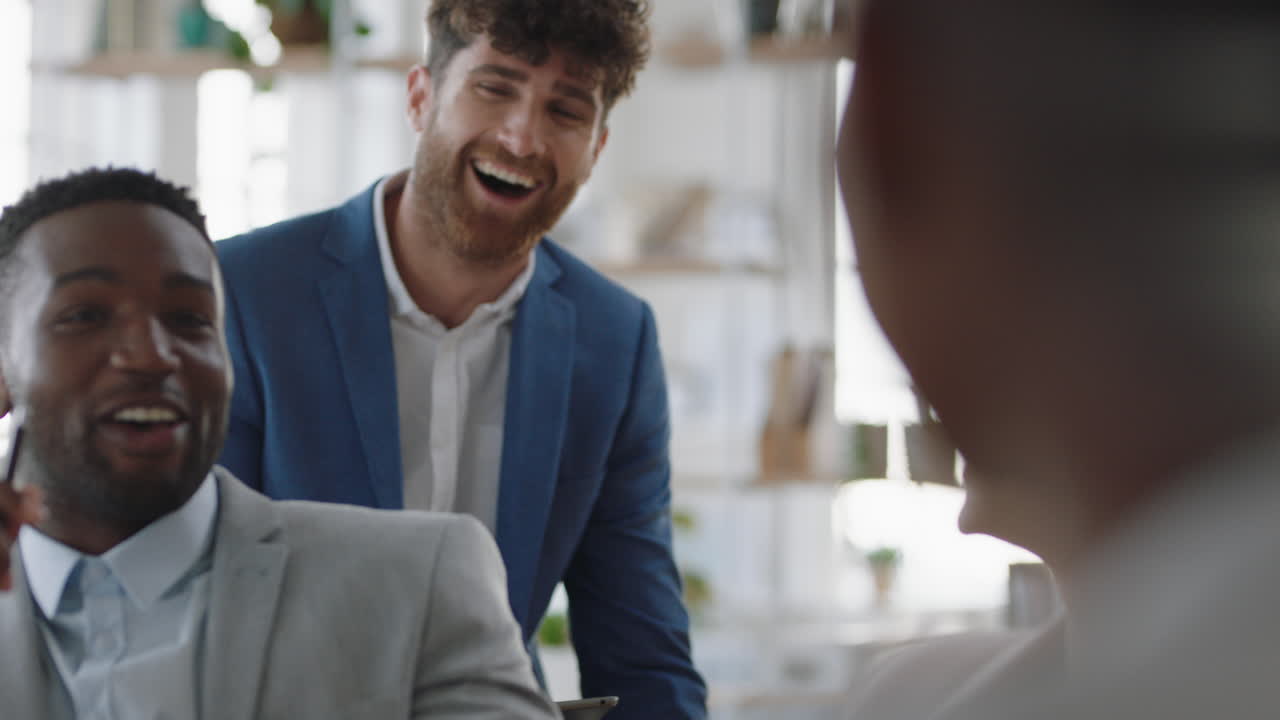 african american businessman chatting with colleagues in office meeting having conversation sharing ideas with diverse corporate group in workplace