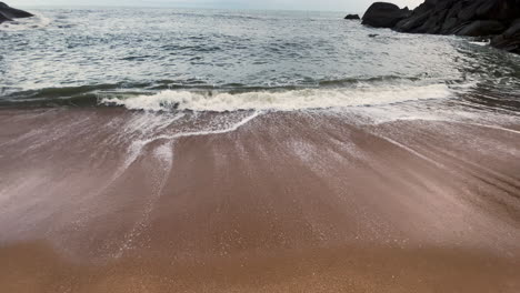 wave and cloudy blue sky butterfly beach goa india 4k tilt up