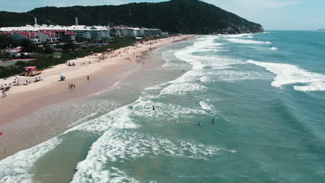 Drone advance over the waves at Praia Brava, Florian&oacute;polis, capturing the dynamic beauty of the coastal scene