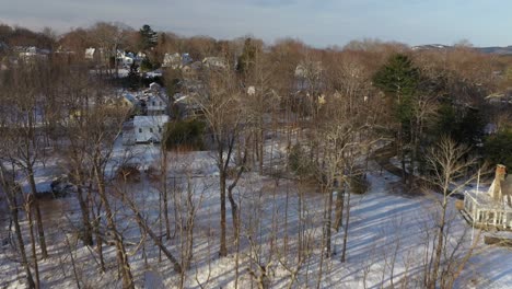 Aerial-footage-flying-towards-and-over-the-wintery-shore-of-Camden-Harbor