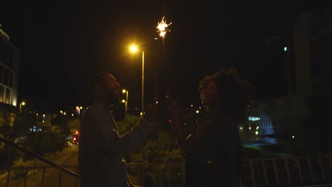 couple holding sparkles in city 4k