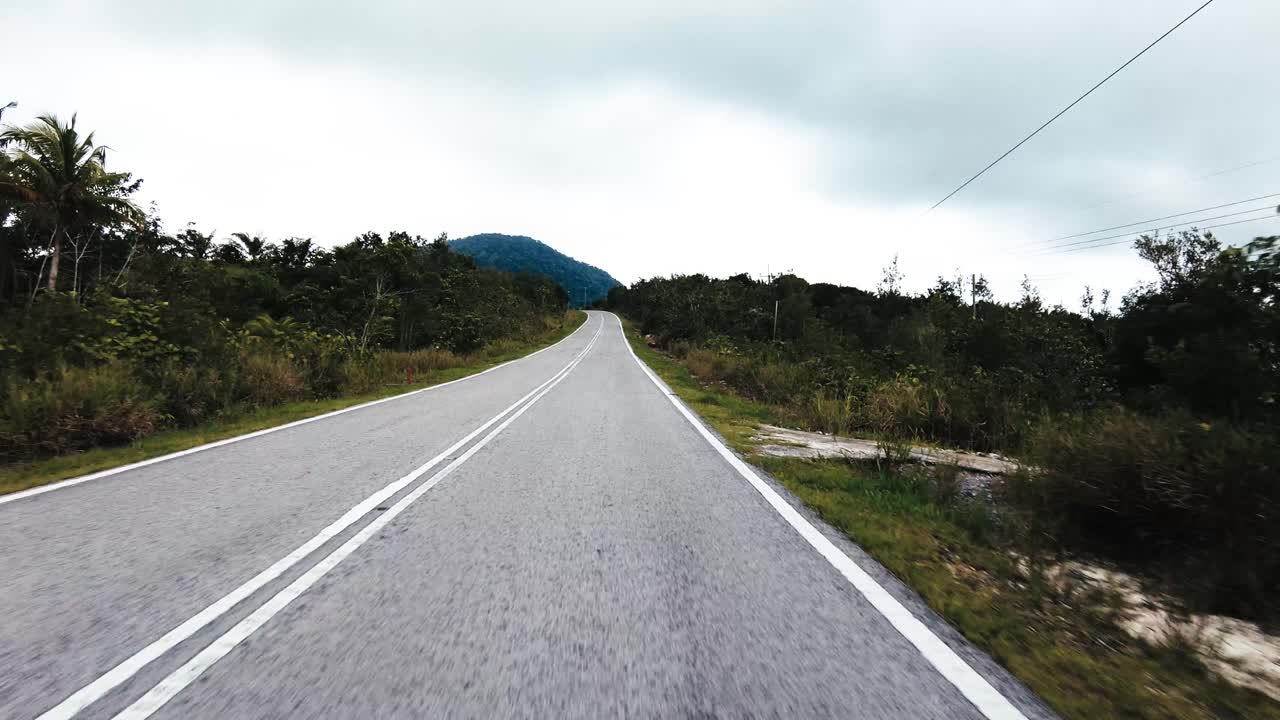 Beautiful View Drive Along Sempadi Lundu Coastal Road with Green Forest and Mountain,Sarawak,Borneo.