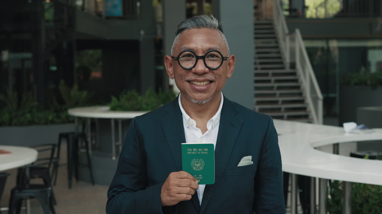 Man Holding a Korean Passport