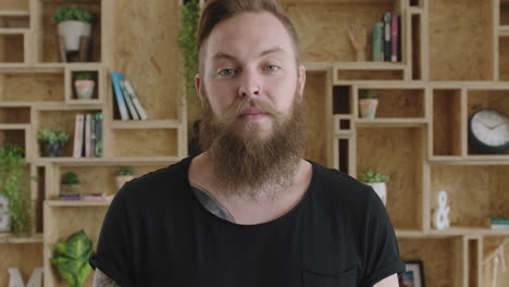 close-up-portrait-of-young-cheerful-hipster-man-with-beard-laughing-happy-feeling-confident