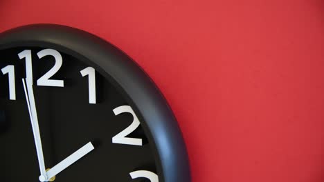 black wall clock on red background