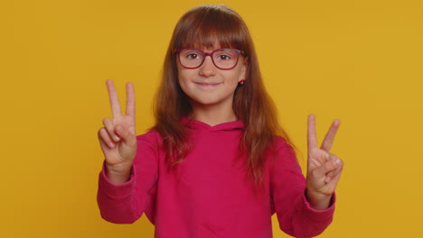 Happy-preteen-child-girl-kid-showing-victory-sign,-hoping-for-success-and-win,-doing-peace-gesture