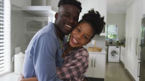 video of happy african american couple embracing at home