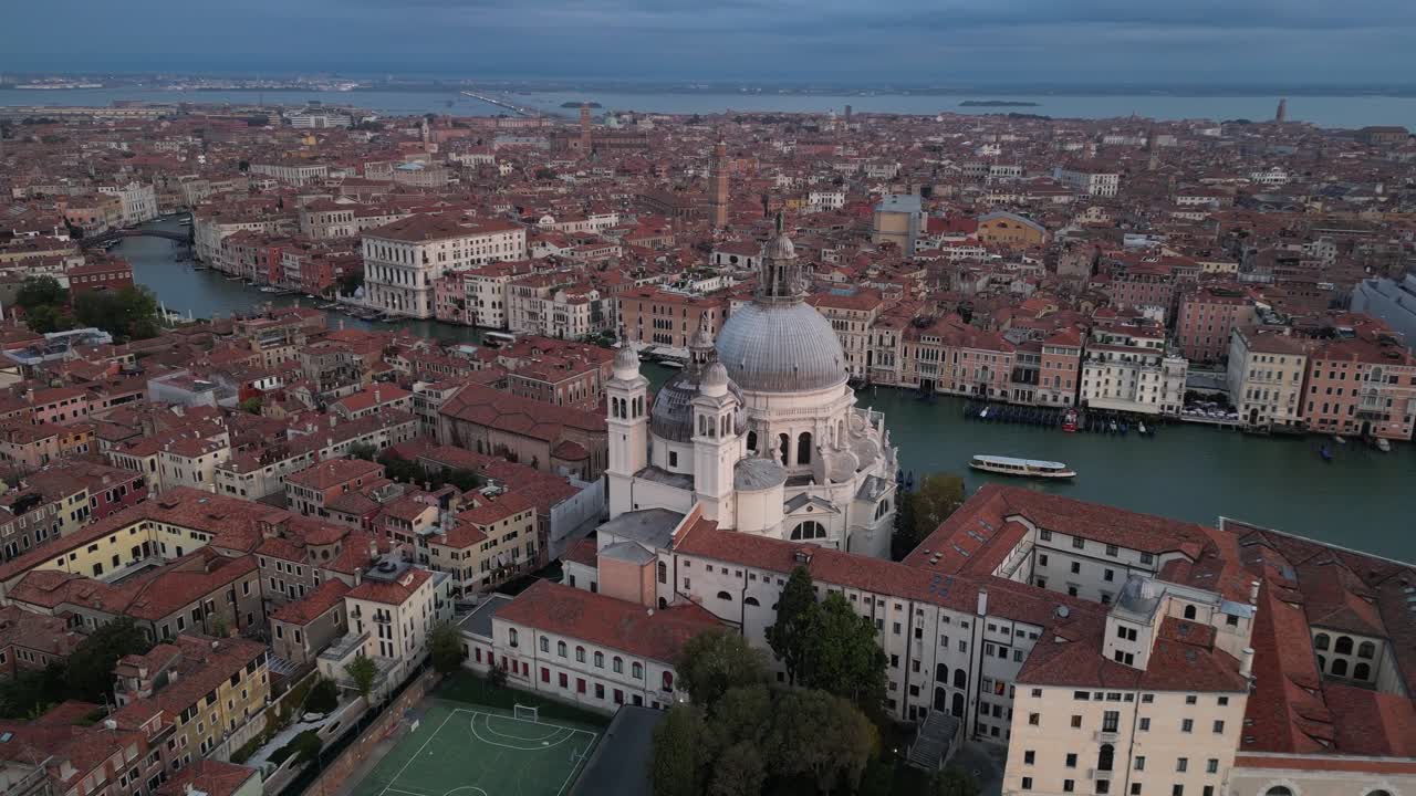 Basilica di Santa Maria della Salute and the Grand Canal in Venice. Wide aerial shot.