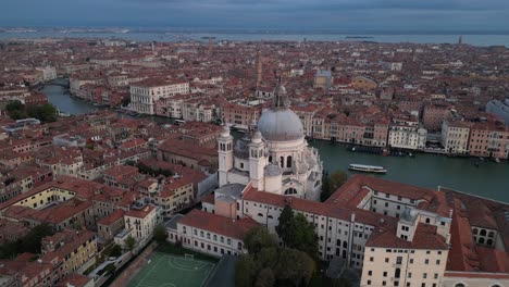 basilica di santa maria della salute and the grand canal in venice. wide aerial shot.