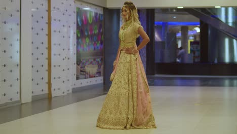 A-beautiful-young-woman-wearing-traditional-Indian-attire-stands-indoors