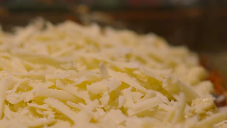fresh parmesan cheese falling in slow motion on top of lasagna italian cuisine dish ready to cook 4k