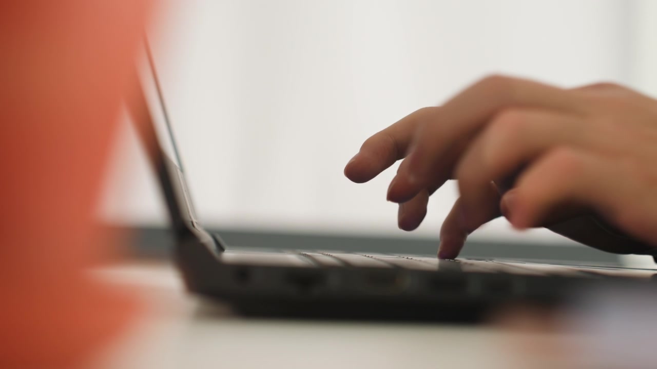 Closeup caucasian hands typing laptop on white desk, soft natural backlight, slow deliberate keystrokes showing freelance writer, remote editor proofreading, student drafting essay, novelist outlining