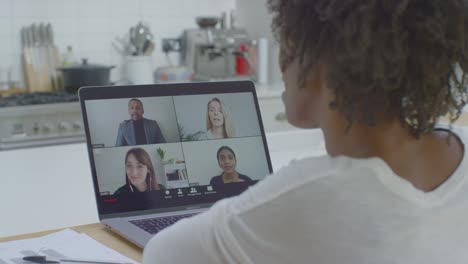 middle aged woman talking to other people on laptop video conference