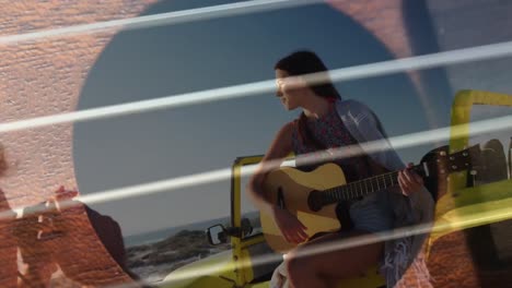 animation of happy caucasian couple with guitar over seascape