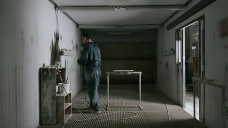 worker spray painting in a workshop