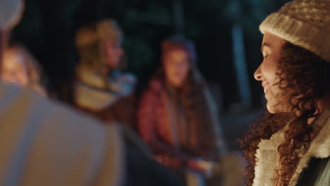 friends camping mixed race woman chatting to man flirting having conversation smiling enjoying romantic connection by campfire 4k