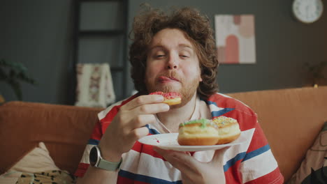 man enjoying donuts on the couch