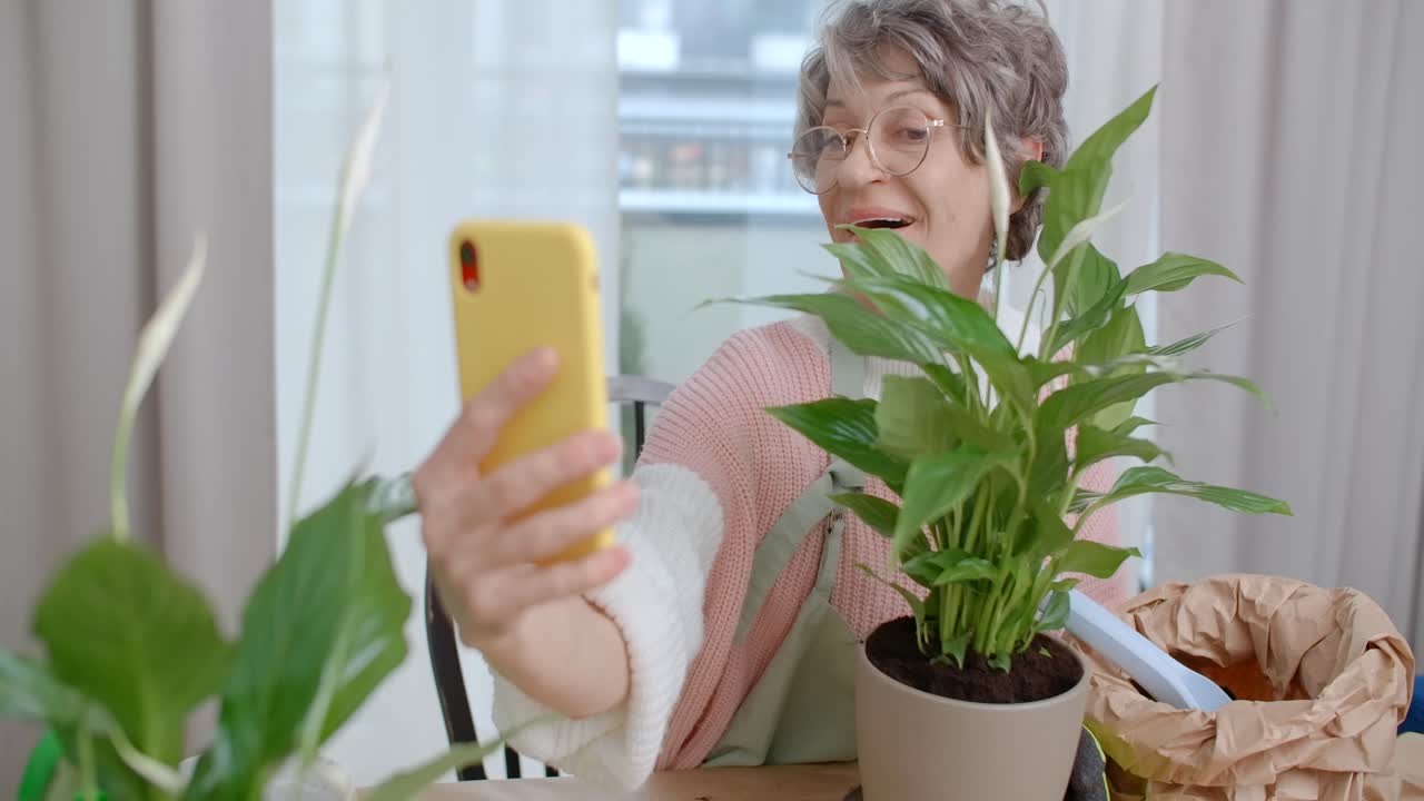 Senior Woman Taking a Video Call While Gardening