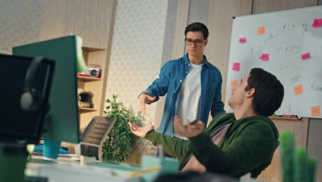 nervous guys communicating together at workplace. two startupers brainstorming