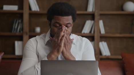 a pensive businessman recieving bad news about crypto market crash on his laptop