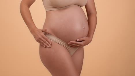 pregnant woman with hands on her belly