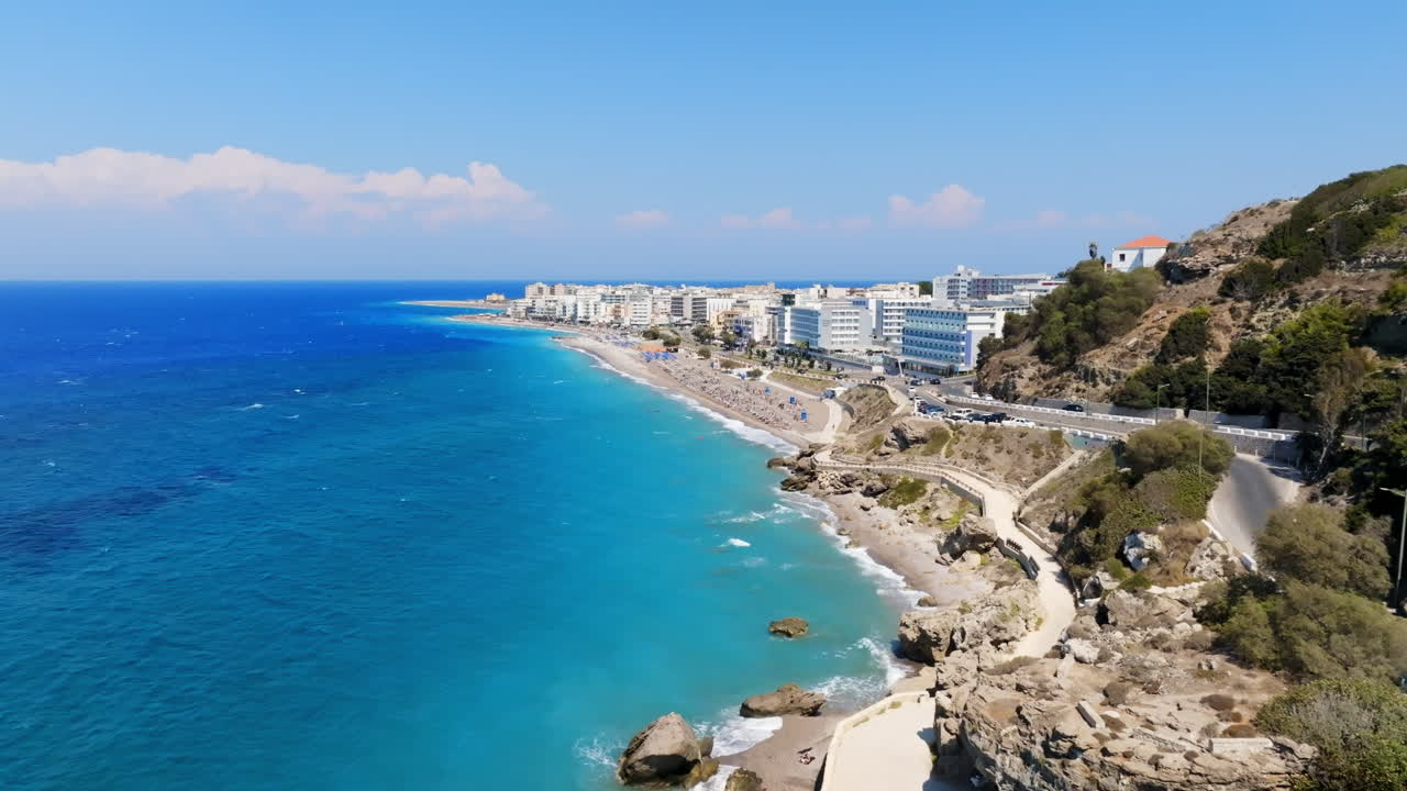 Aerial view following the coastline of the Rhodes city, sunny day in Greece