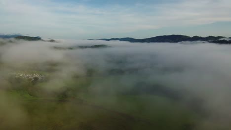 costa rica landscape through the clouds, aerial reveal from above