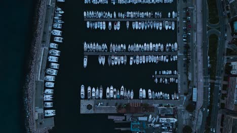 twilight aerial view of menton marina on the french riviera, showcasing neat rows of moored boats