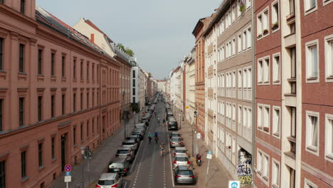 Forwards-tracking-shot-of-cyclists-riding-through-Linienstrasse,-street-changed-to-cycle-route.-Promoting-green-transport-in-city.-Berlin,-Germany.