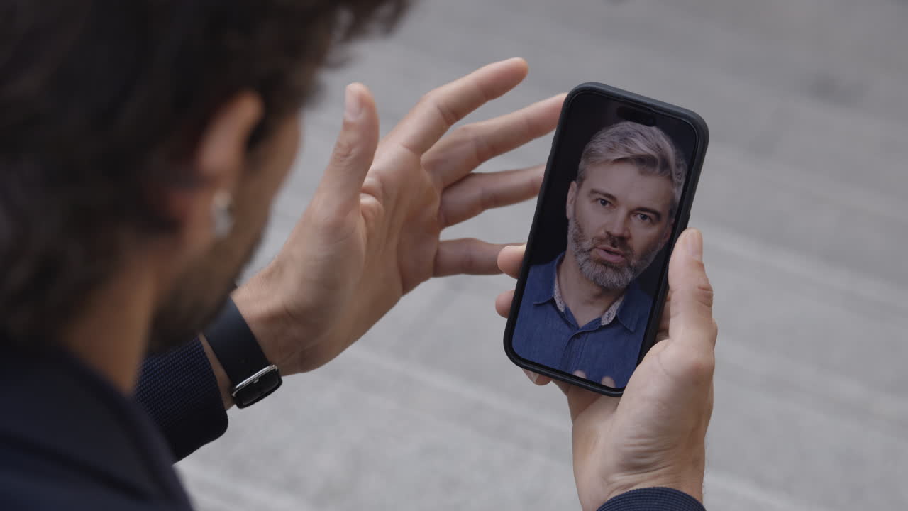 Man Having a Video Call on Smartphone Outdoors