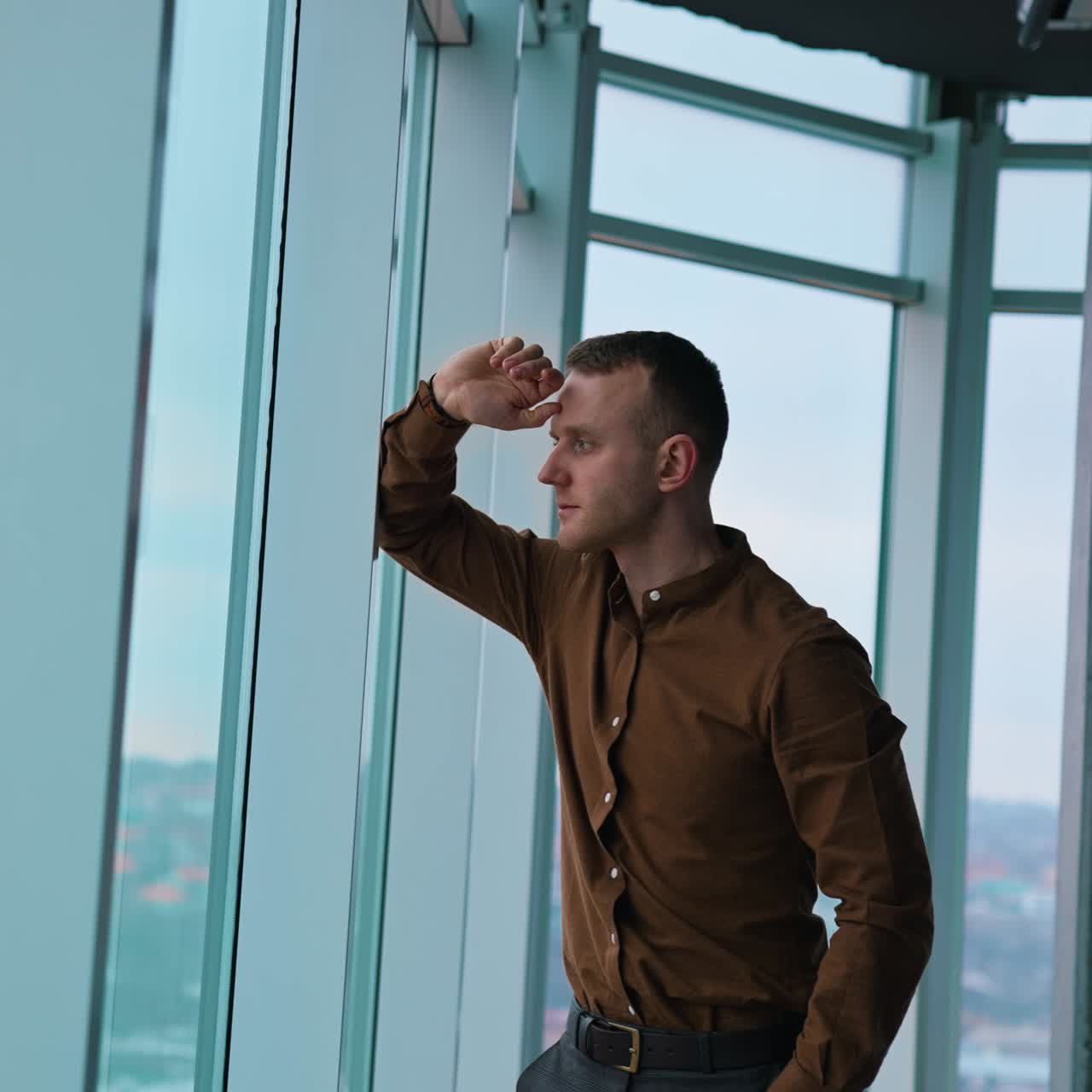 Businessman look through window when work in the night