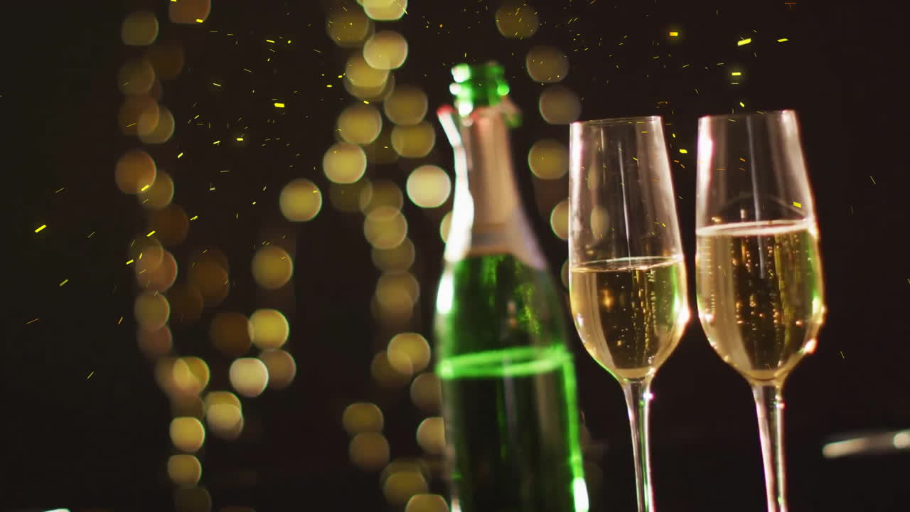 Animation of confetti over glasses and bottle of champagne