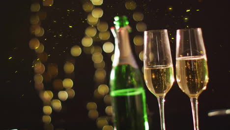 animation of confetti over glasses and bottle of champagne