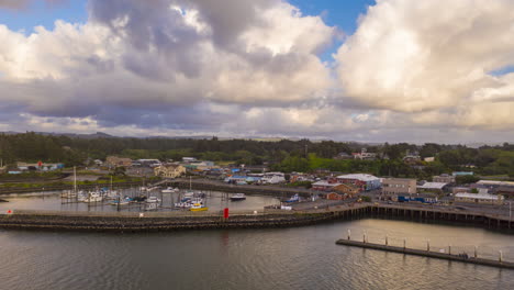Clouds-Flying-By-Above-Port-Of-Bandon-In-Oregon-In-An-Overcast-Weather---hyper-lapse,-arc-shot