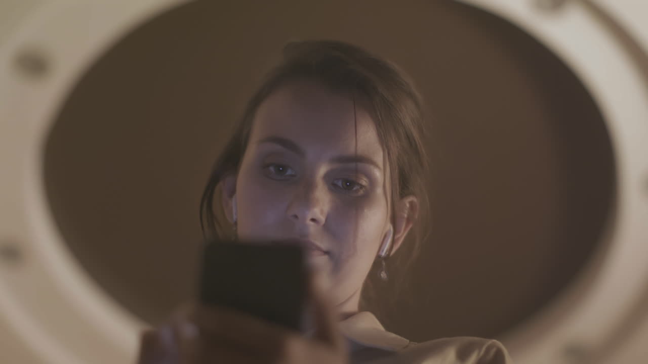 Woman using smartphone in front of a mirror