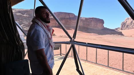 man looking at the views from his bubble camp to wadi rum