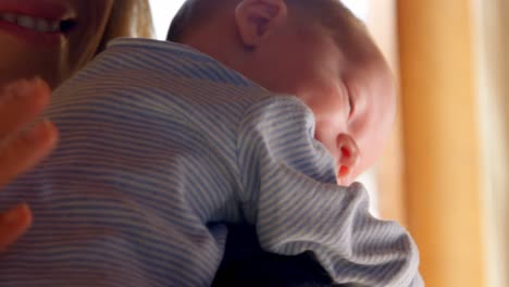 mother consoling her baby boy in living room 4k