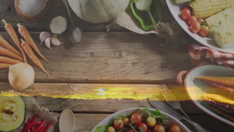 animation of landscape over plates with food on wooden background