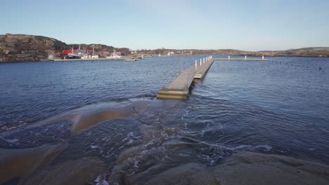 a boat dock surrounded by water on a coast in southern norway