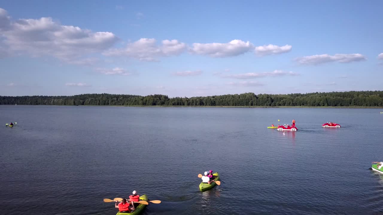 People enjoying various water activities on a calm lake
