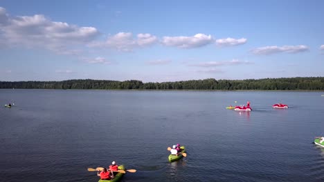 people enjoying various water activities on a calm lake
