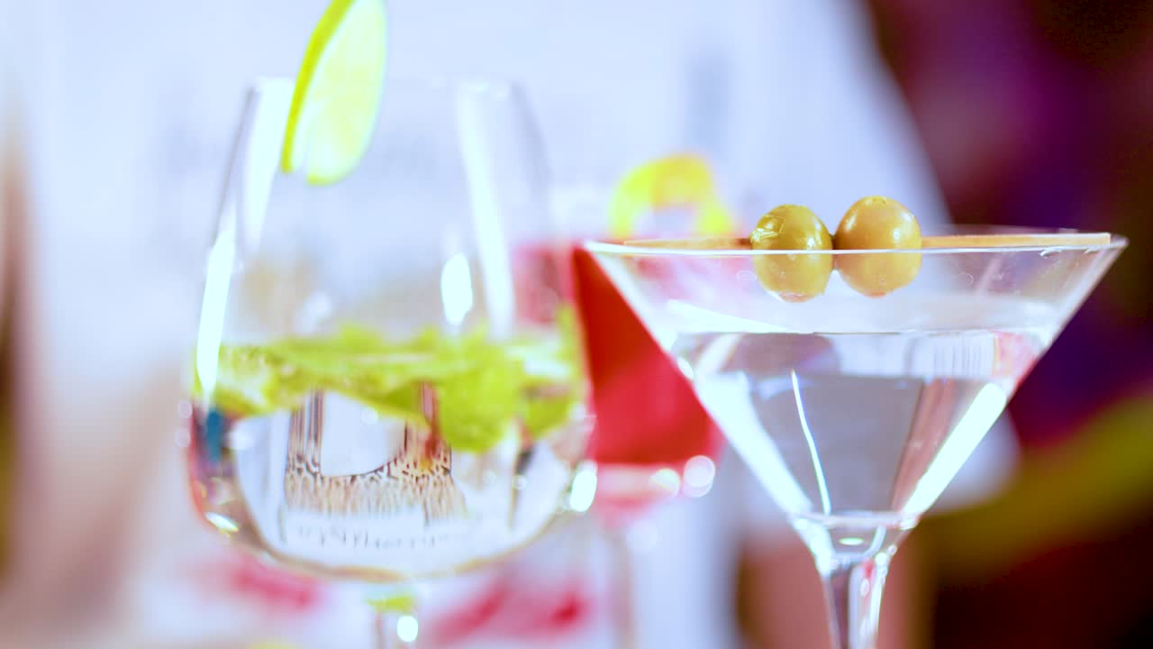 Colorful cocktails with garnishes in a bright setting, highlighting martini glasses and vibrant drinks