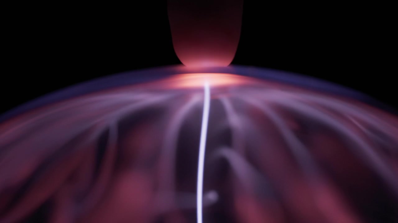A finger touching plasma ball, creating white energy ray
