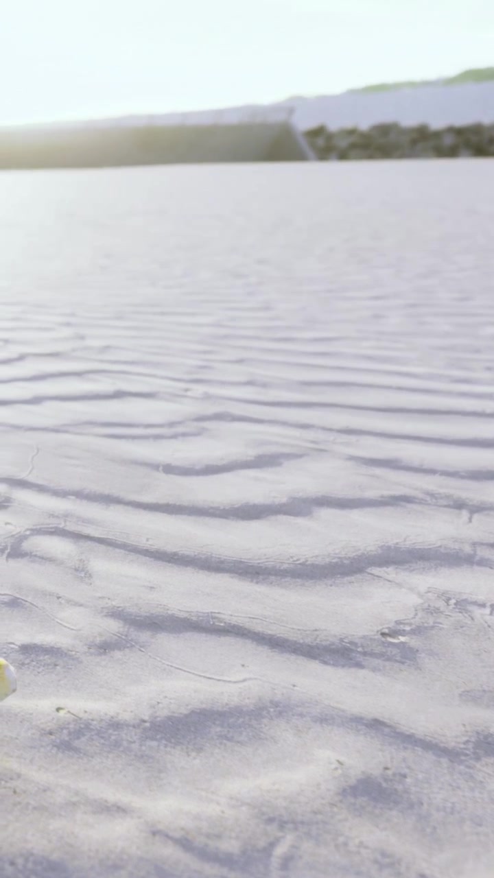 Sand patterns in desert area during daylight hours near mountains