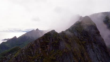 Aerial-view-of-Reinebringen-in-the-clouds,-Reine,-Lofoten-Islands,-Norway