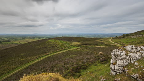 Time-lapse-of-rural-and-remote-landscape-of-grass,-trees-and-rocks-during-the-day-in-hills-of-Carrowkeel-in-county-Sligo,-Ireland