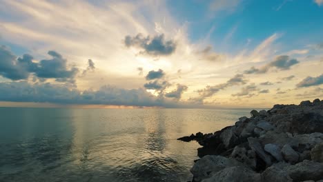A-time-lapse-of-the-setting-sun-over-the-ocean-near-Ambergris-Caye-or-Bay,-Belize