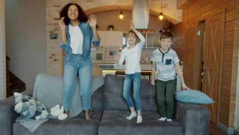 kids dancing on a sofa