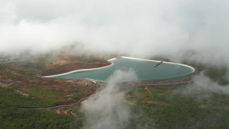 Water-reservoir-surrounded-by-dreamy-clouds-high-in-mountains-of-Madeira