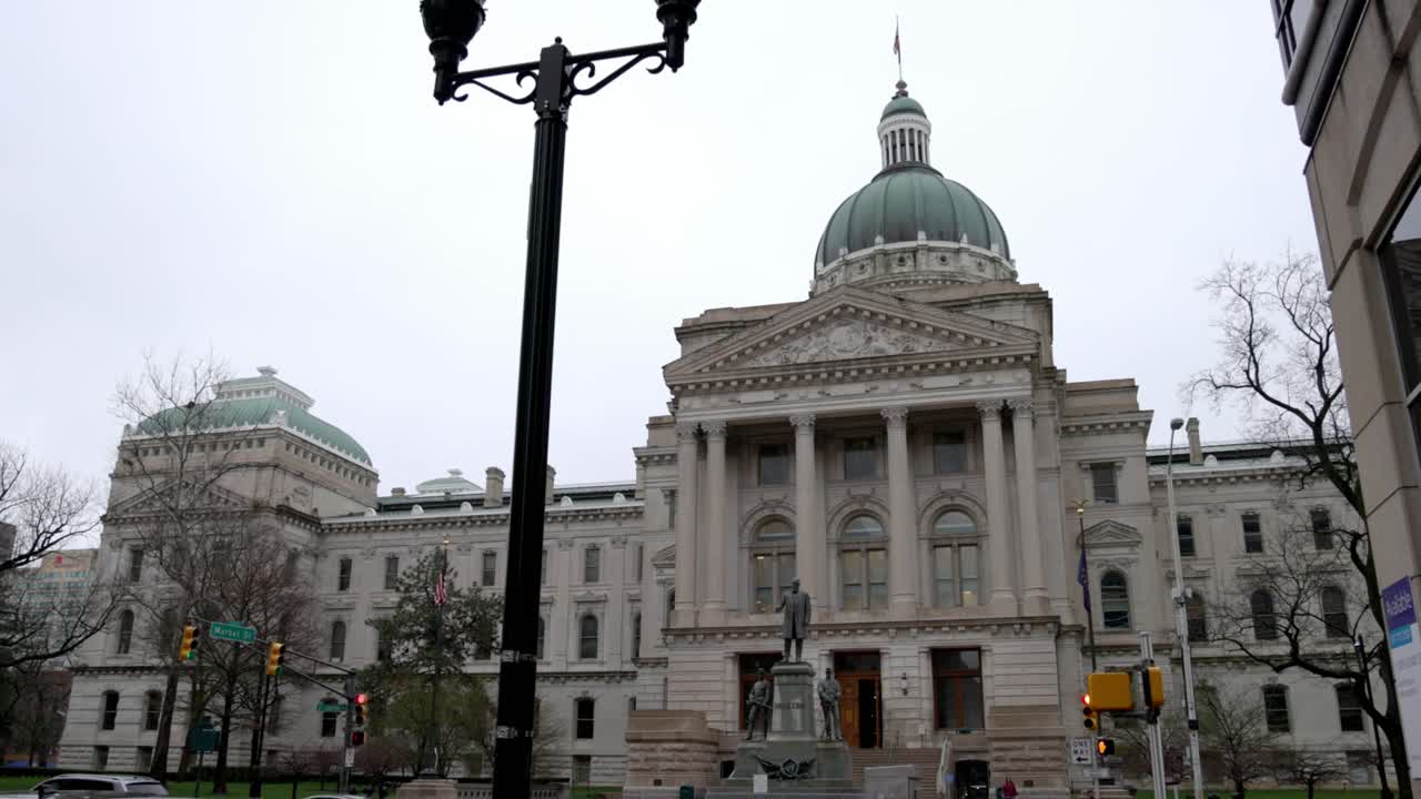 Shot on the outside of the Indiana State Capitol building in Indianapolis, Indiana with cars driving by.